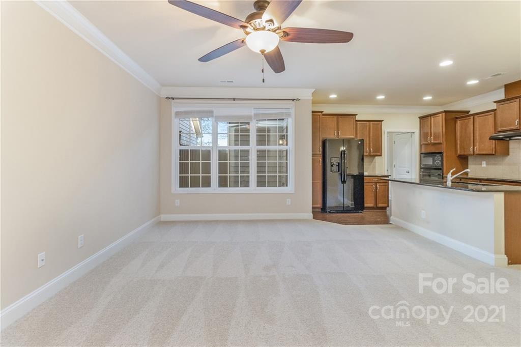 2263 Eversham Drive Northwest Concord, NC 28027 - Photo 8 of 21 a view of an empty room with kitchen view and a window