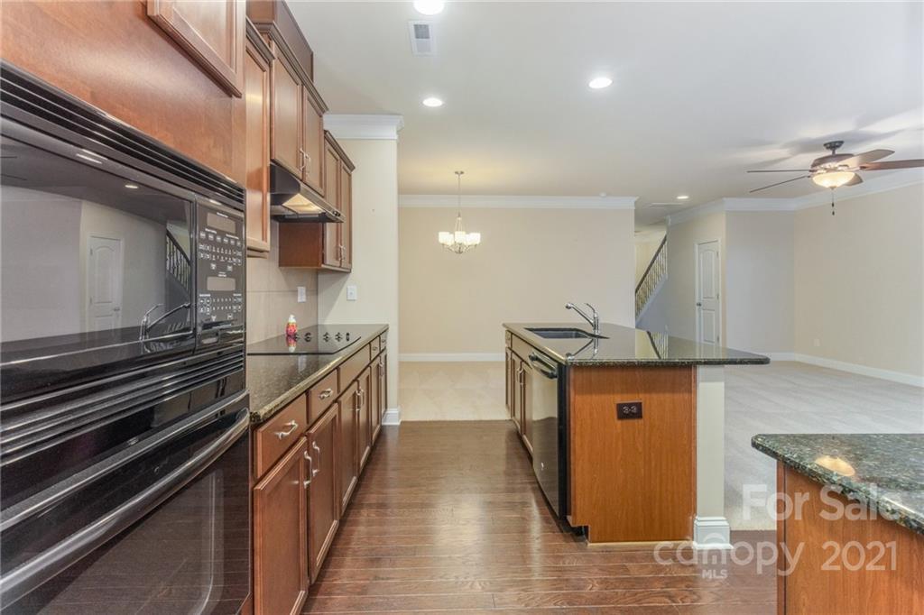 2263 Eversham Drive Northwest Concord, NC 28027 - Photo 9 of 21 a kitchen with stainless steel appliances granite countertop a sink and a stove