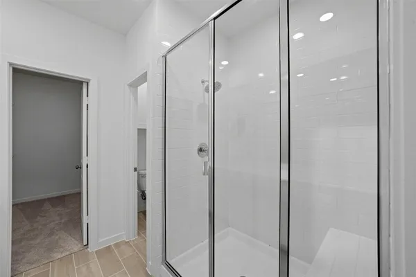 a bathroom with a glass shower door