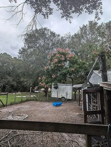 a backyard of a house with table and chairs