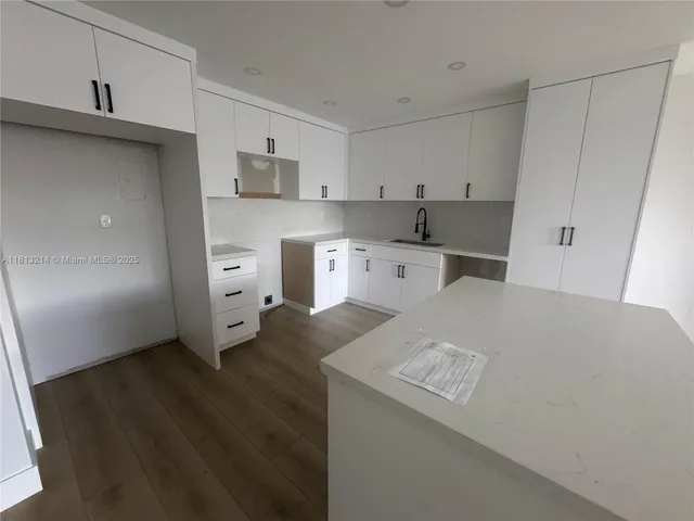 a open kitchen with a sink a stove and refrigerator