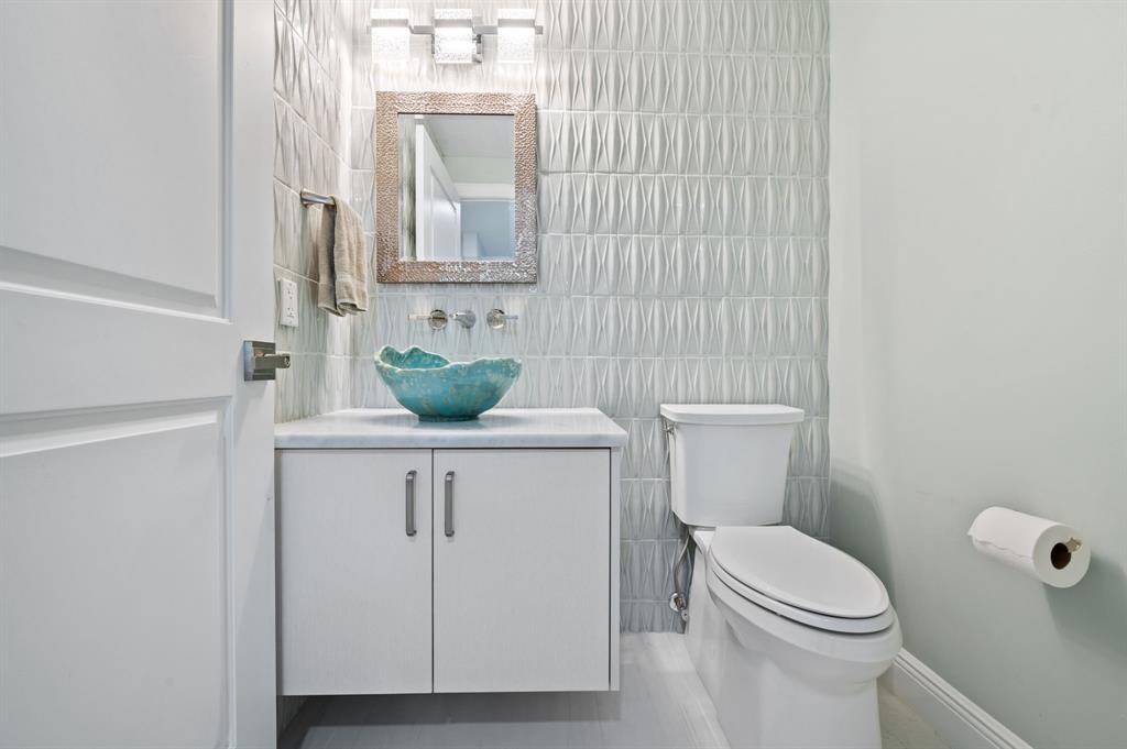400 Hendricks Isle, Unit 3A Fort Lauderdale, FL 33301 - Photo 27 of 37 a bathroom with a granite countertop toilet sink and mirror