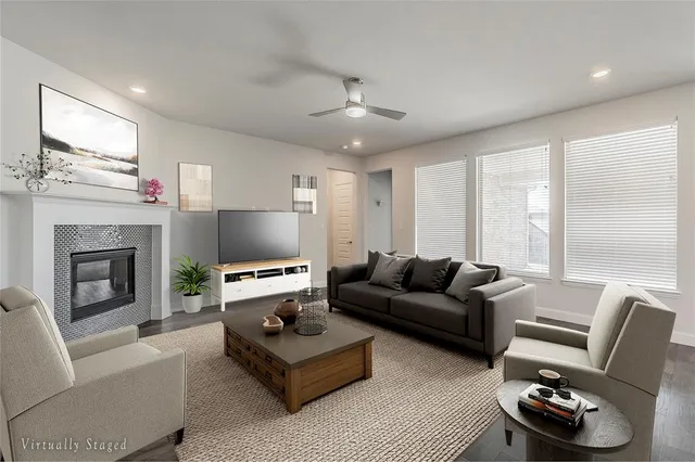 a living room with furniture a fireplace and a flat screen tv