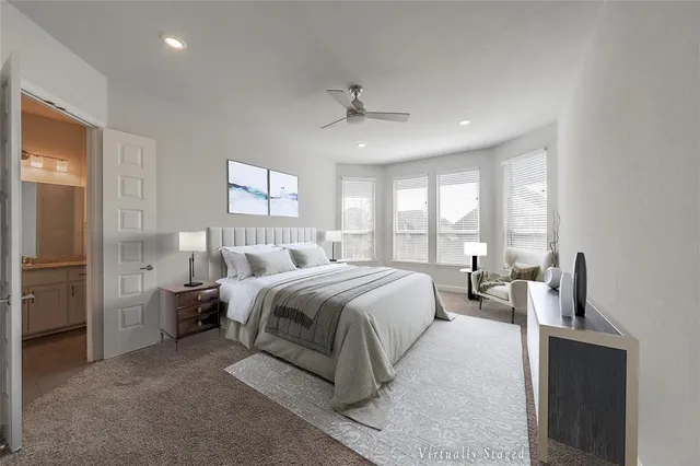 a spacious bedroom with a bed and a chandelier