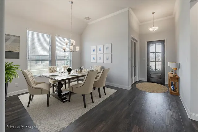 a view of a a dining room with furniture window and wooden floor