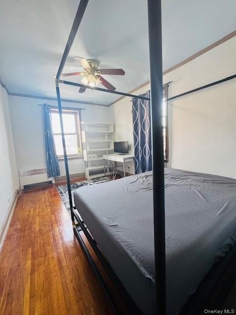 48-20 44th Street, Unit 4C Queens, NY 11377 - Photo 12 of 12 Bedroom featuring hardwood / wood-style flooring, a ceiling fan, crown molding, and radiator