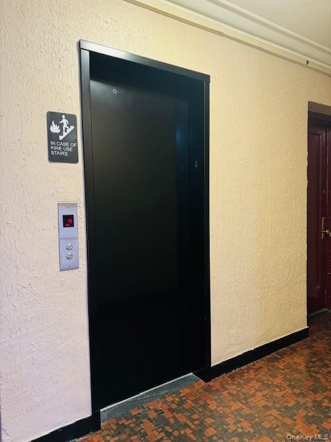48-20 44th Street, Unit 4C Queens, NY 11377 - Photo 3 of 12 Elevator featuring a textured wall and carpet