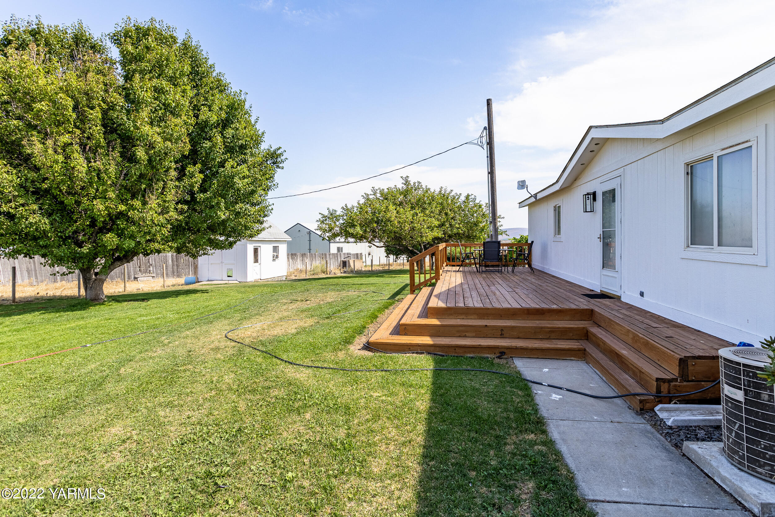 341 Winchester Road Yakima, WA 98908 - Photo 32 of 38 a view of a house with backyard and a tree