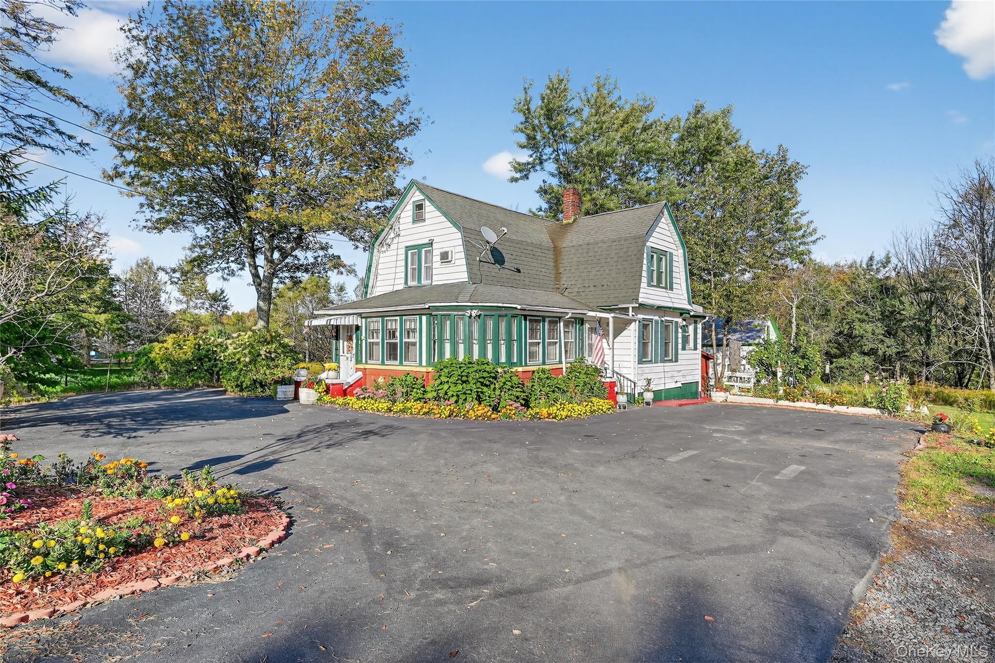 a view of a house with a yard and sitting area