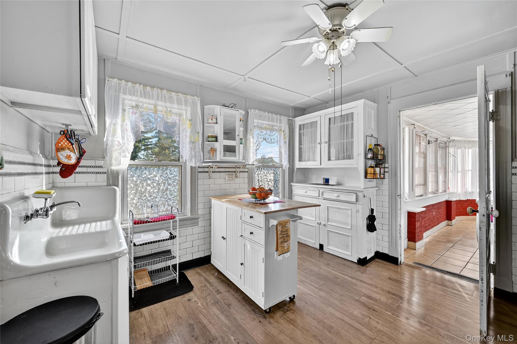 194 Old Liberty Road Monticello, NY 12701 - Photo 12 of 33 a kitchen with stainless steel appliances white cabinets and wooden floors