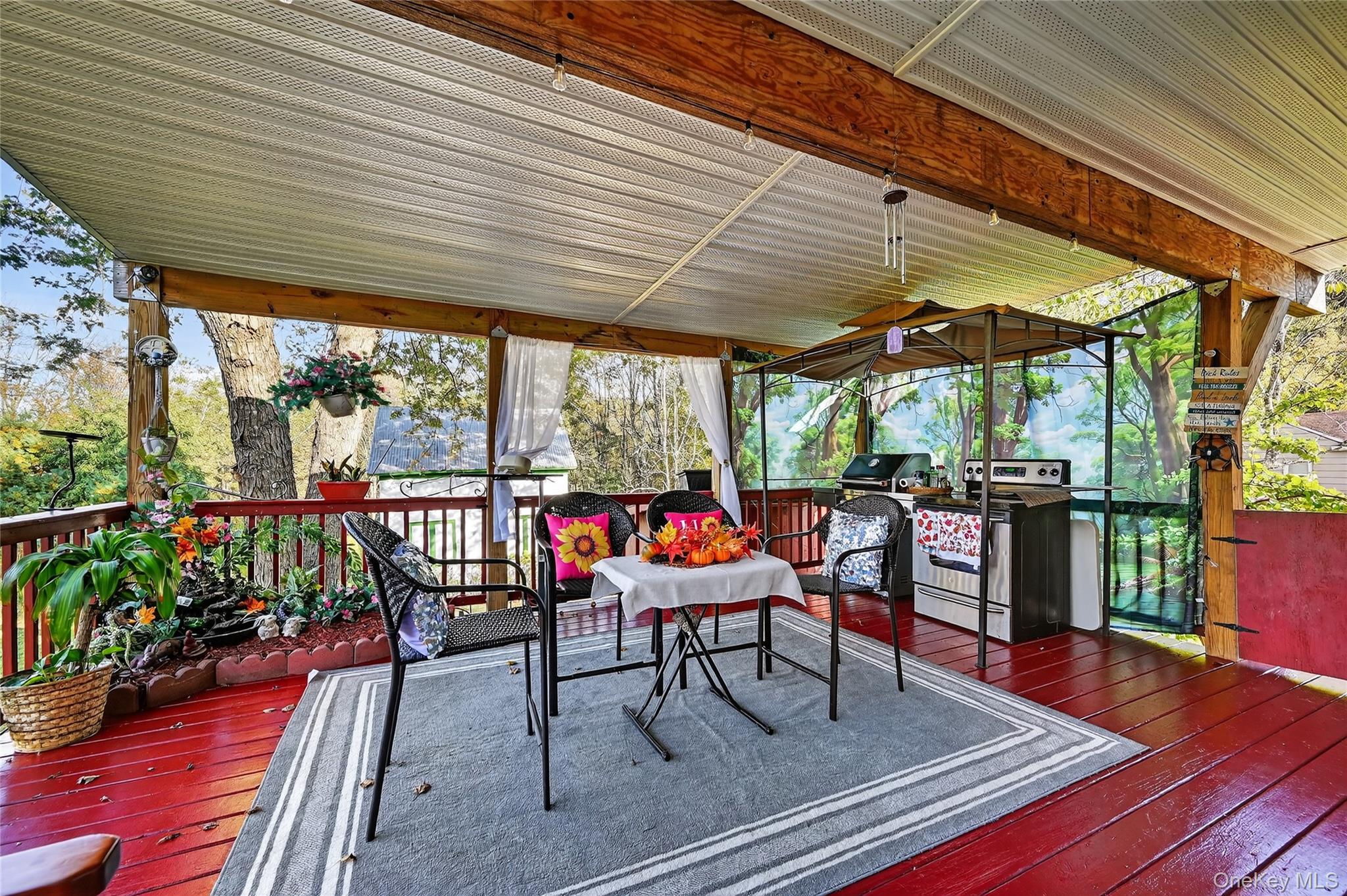 194 Old Liberty Road Monticello, NY 12701 - Photo 27 of 33 an outdoor sitting area with furniture and wooden floor