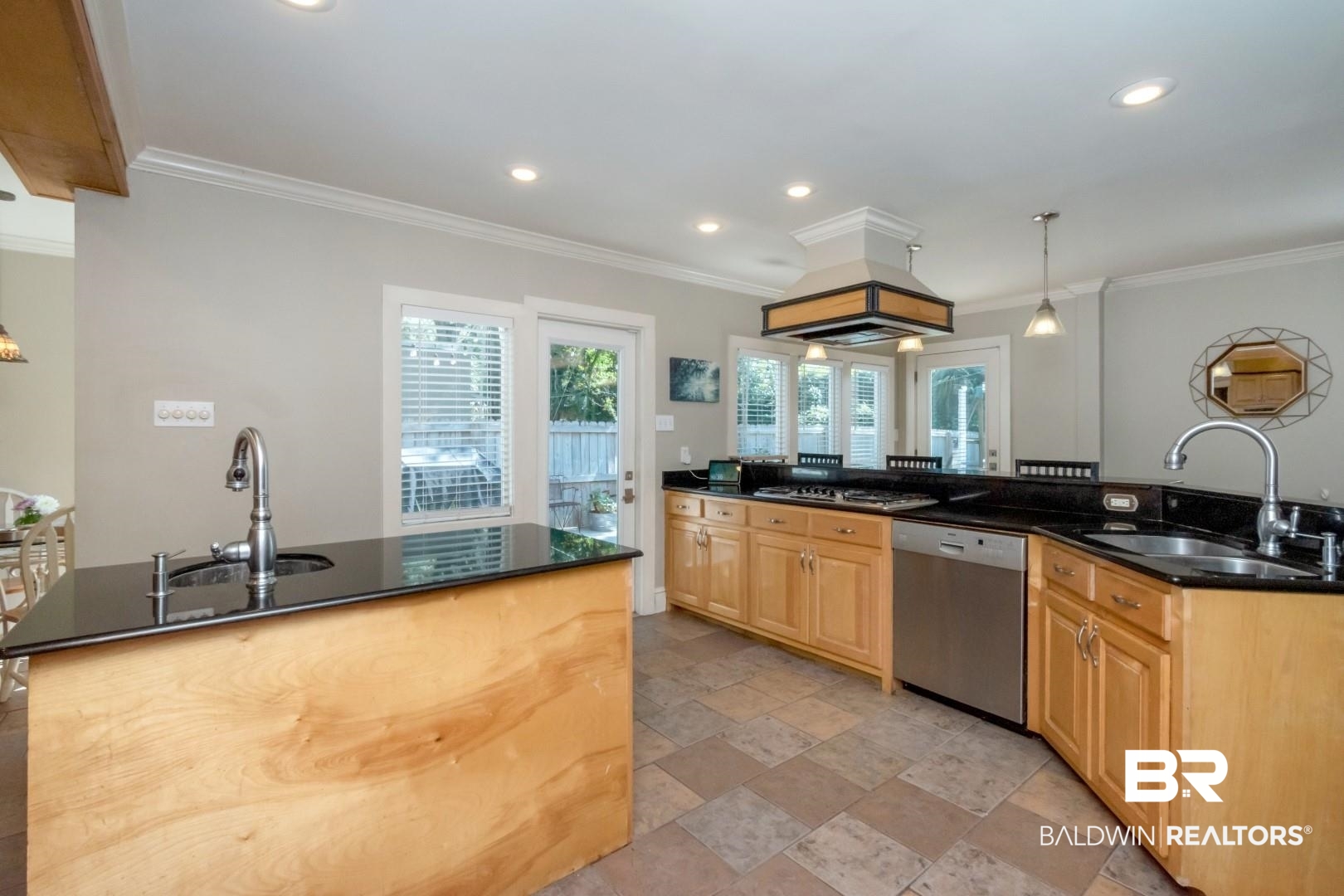 116 Florence Place Mobile, AL 36607 - Photo 13 of 41 Kitchen with light tile patterned floors, stainless steel appliances, decorative light fixtures, and sink