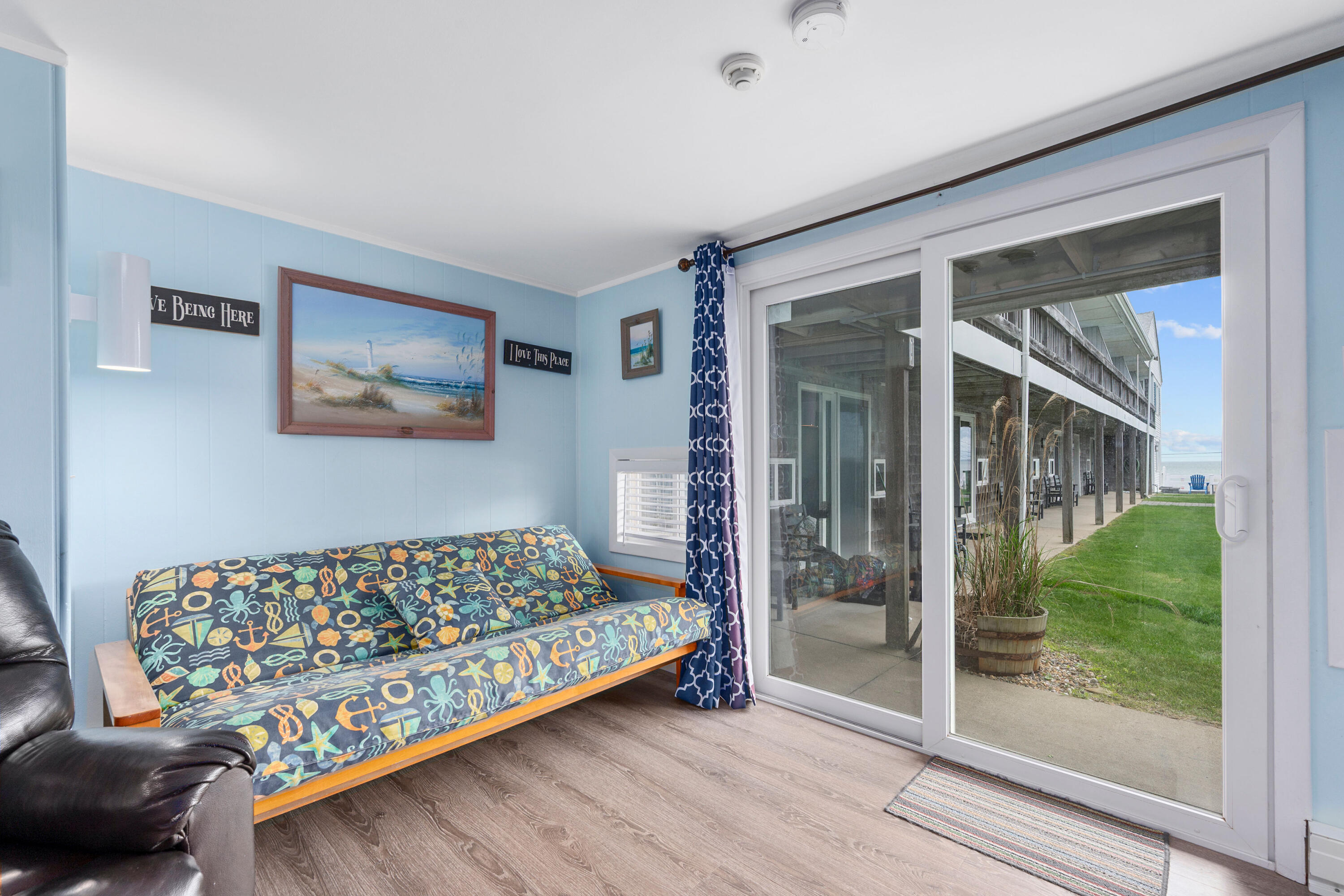 154 Old Wharf Road, Unit 26 Dennis Port, MA 02639 - Photo 2 of 6 a bedroom with a bed and a painting on the wall