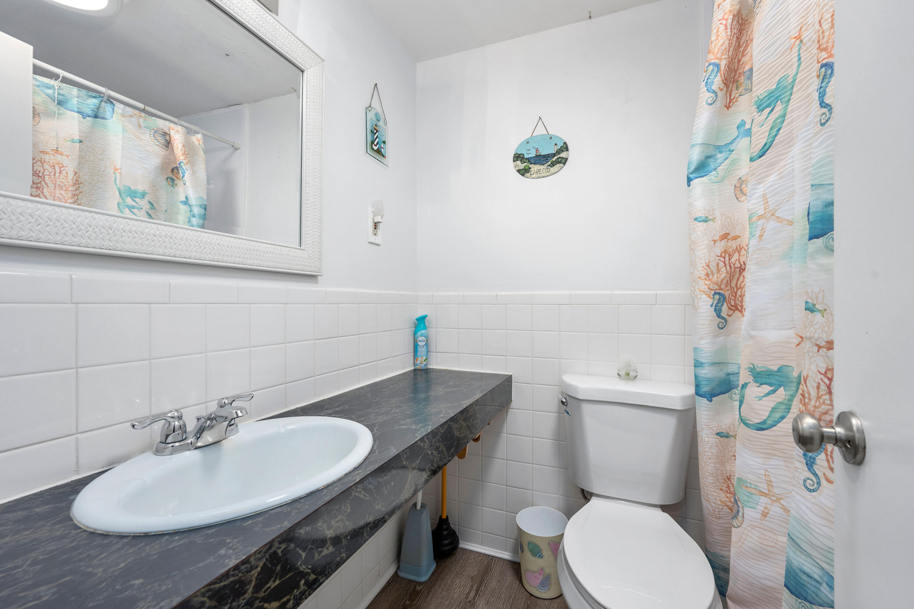 154 Old Wharf Road, Unit 26 Dennis Port, MA 02639 - Photo 6 of 6 a bathroom with a sink a toilet and a mirror