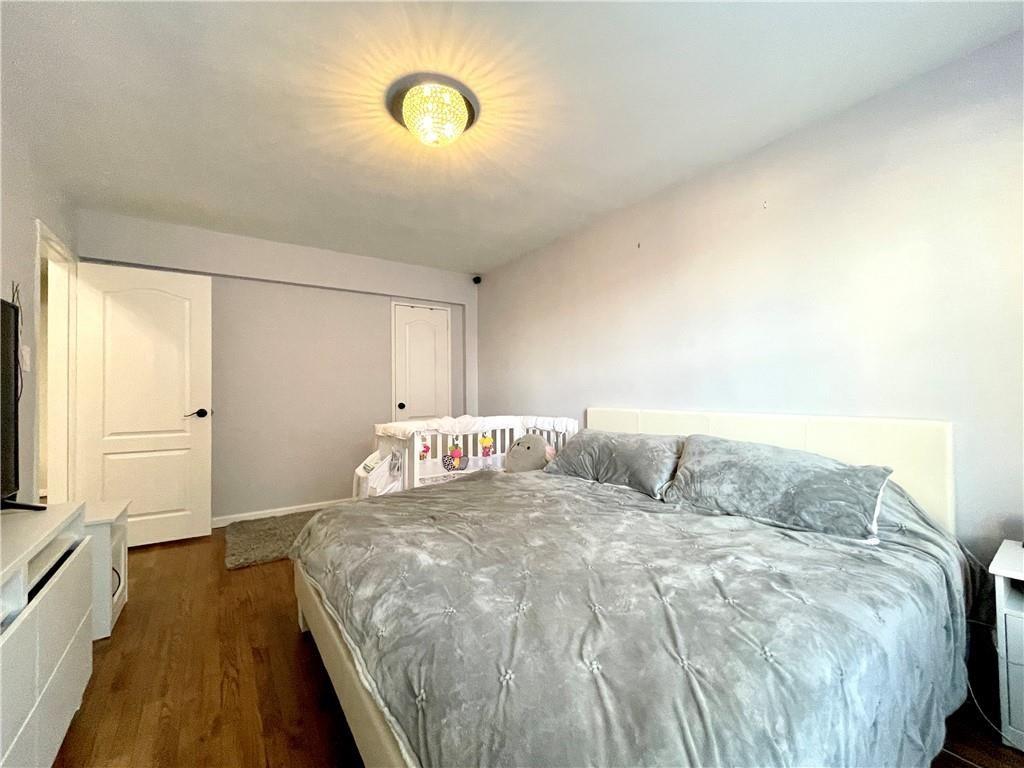 3235 Emmons Avenue, Unit 516 Brooklyn, NY 11235 - Photo 3 of 3 a bedroom with a bed and a flat screen tv