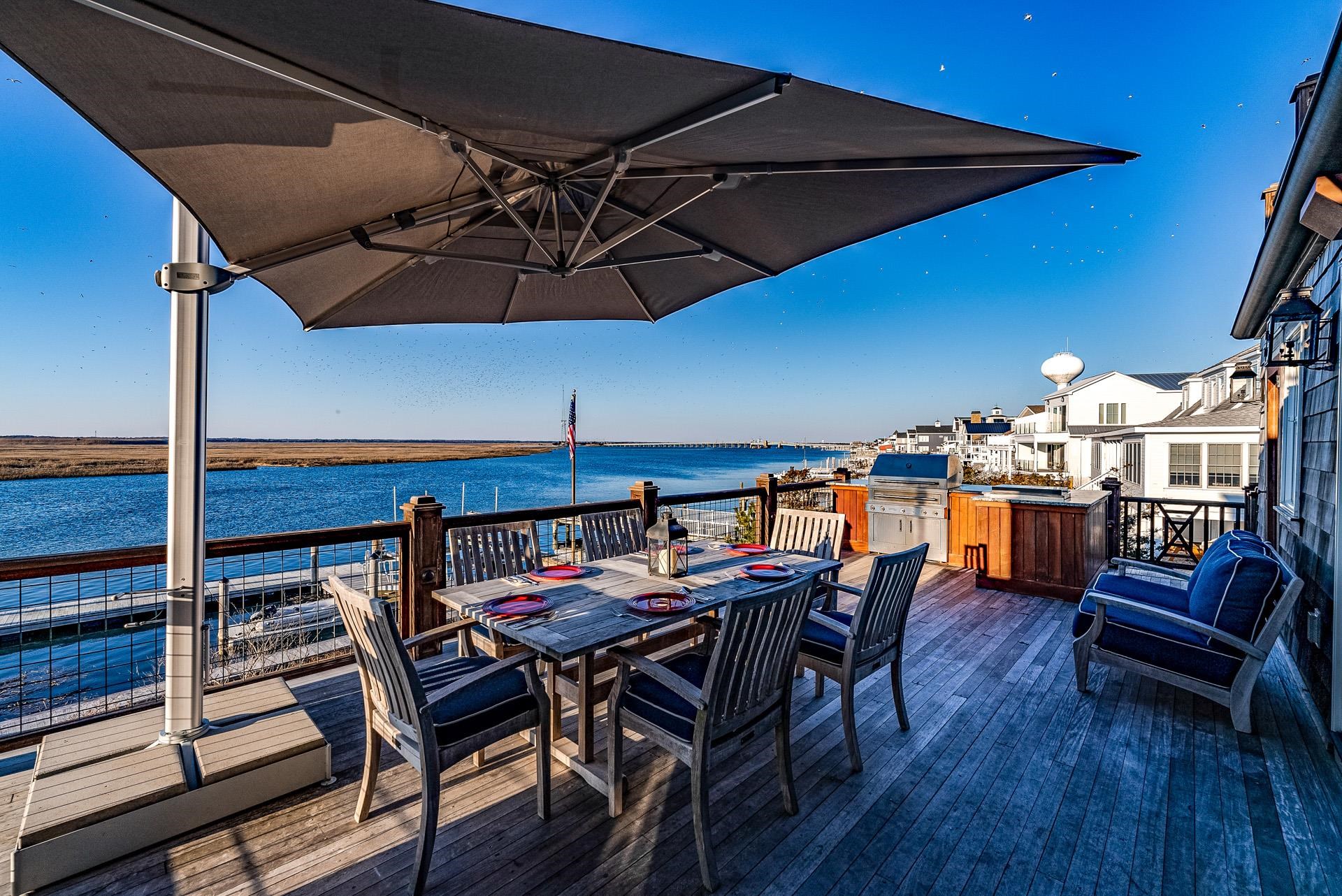 612 South Bayview Strathmere, NJ 08248 - Photo 24 of 38 a view of a patio with table and chairs under an umbrella