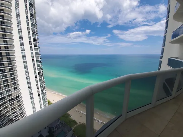 a view of kitchen with microwave and refrigerator