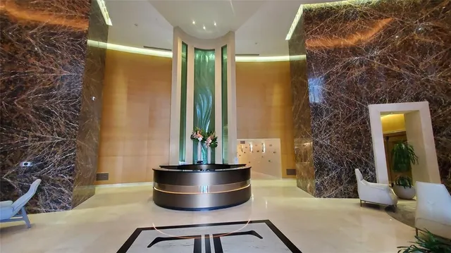 a living room with a couch and a potted plant