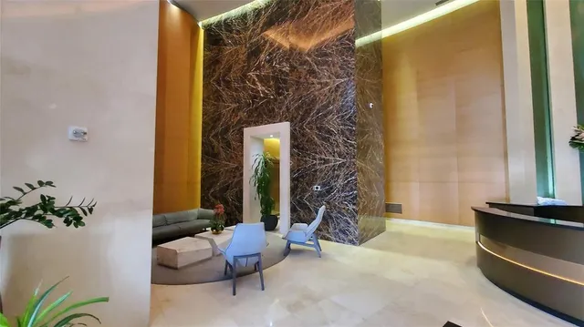 a living room with a couch and a potted plant