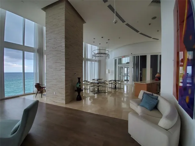 a lobby with furniture and floor to ceiling window
