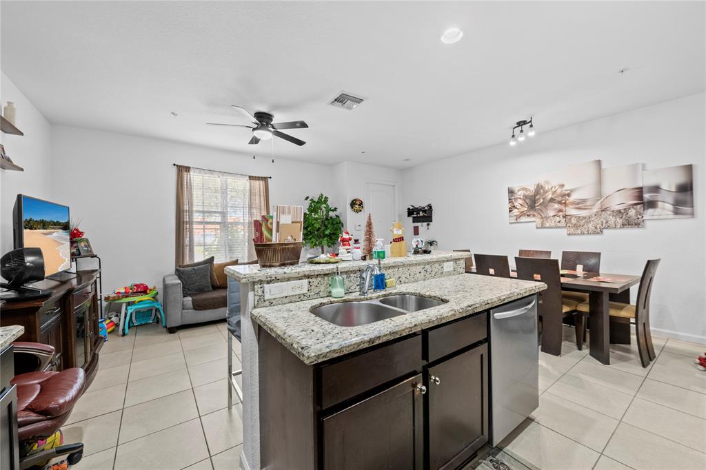 197 Southwest 6th Place, Unit 197 Pompano Beach, FL 33060 - Photo 11 of 25 a dining hall with stainless steel appliances granite countertop a sink and a refrigerator