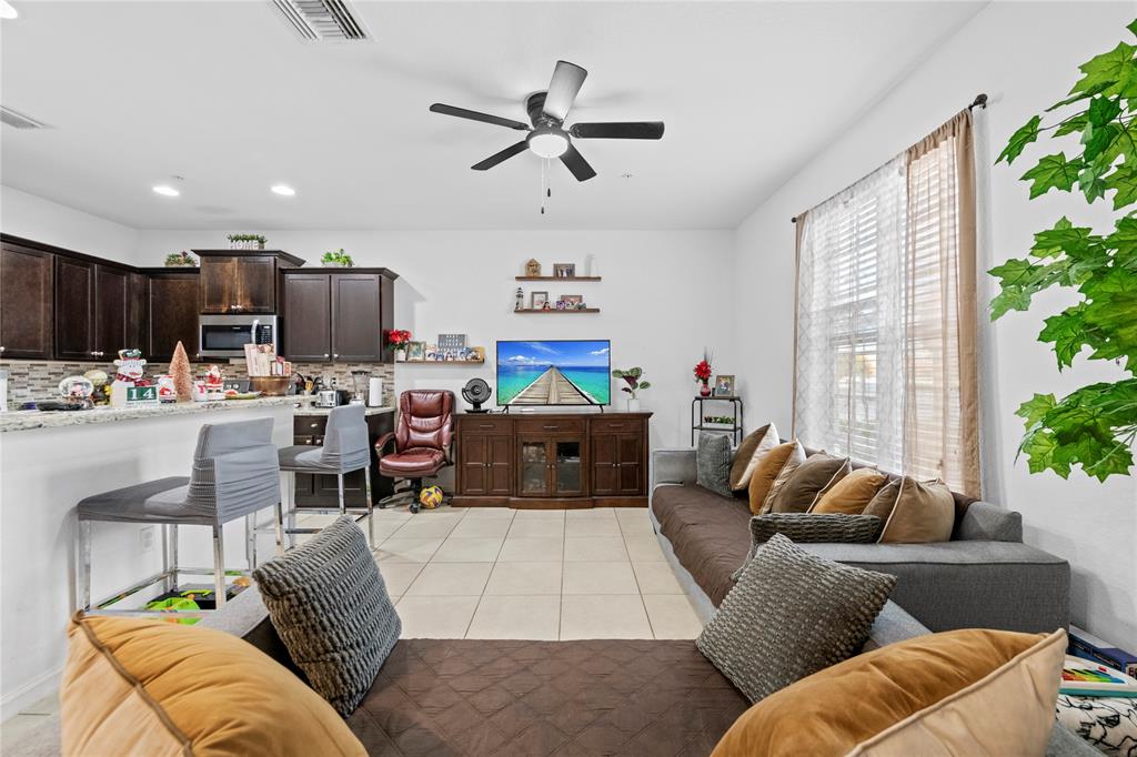 197 Southwest 6th Place, Unit 197 Pompano Beach, FL 33060 - Photo 12 of 25 a living room with furniture kitchen and a window