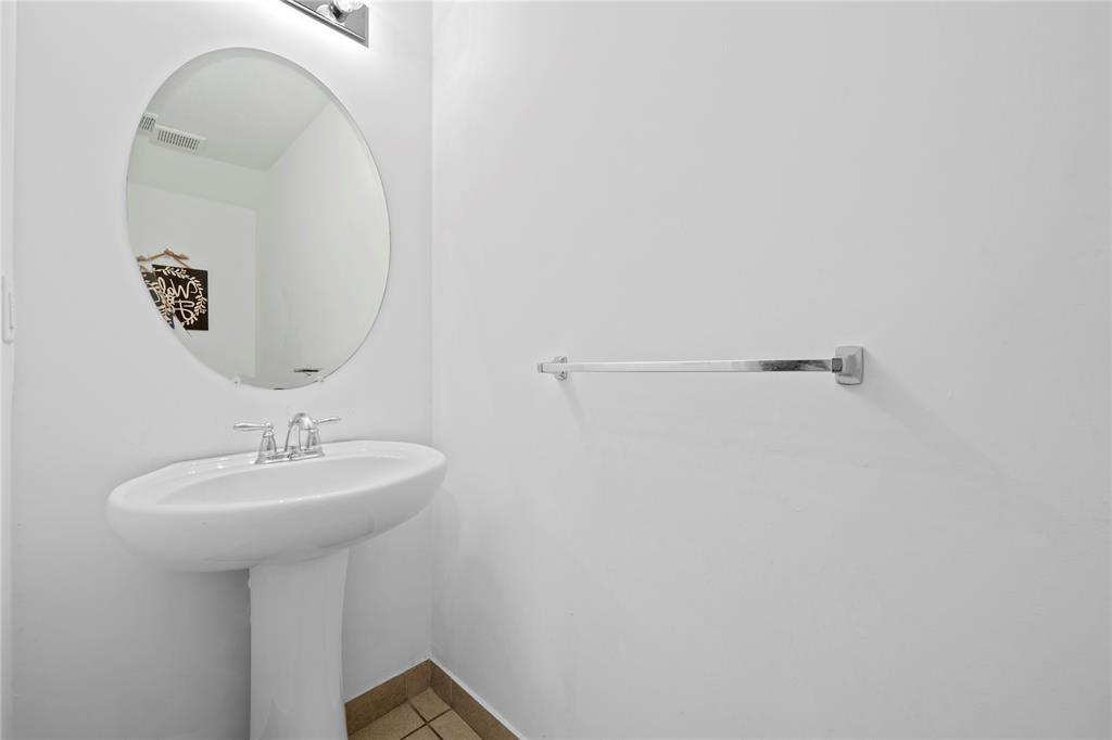 197 Southwest 6th Place, Unit 197 Pompano Beach, FL 33060 - Photo 16 of 25 a bathroom with a sink a mirror and shower