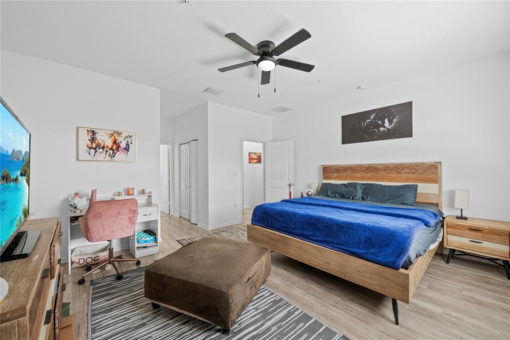 197 Southwest 6th Place, Unit 197 Pompano Beach, FL 33060 - Photo 18 of 25 a bedroom with a bed and wooden floor