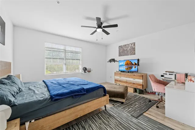 a bedroom with a bed and wooden floor