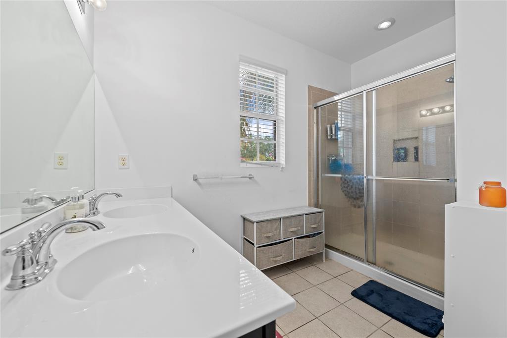 197 Southwest 6th Place, Unit 197 Pompano Beach, FL 33060 - Photo 21 of 25 a bathroom with a sink a toilet and shower