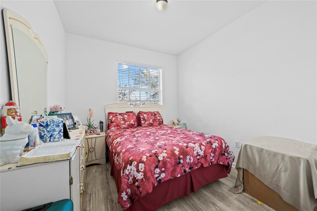 197 Southwest 6th Place, Unit 197 Pompano Beach, FL 33060 - Photo 22 of 25 a bedroom with a bed and a dresser