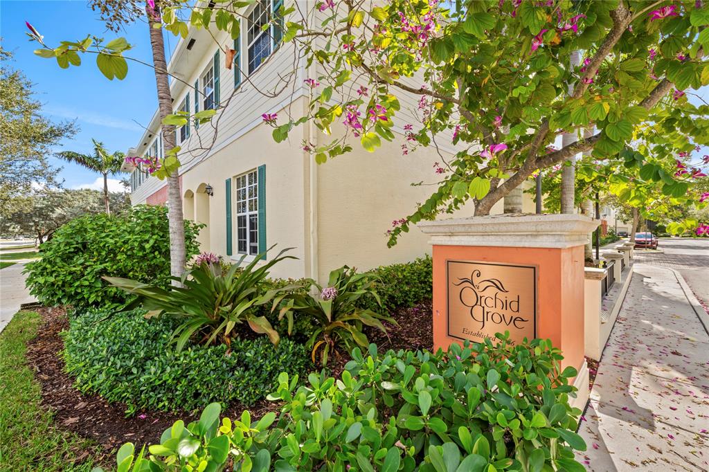 197 Southwest 6th Place, Unit 197 Pompano Beach, FL 33060 - Photo 3 of 25 a sign that is sitting in front of a house with potted plants