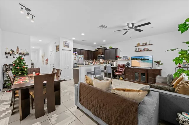 a living room with furniture kitchen and a chandelier