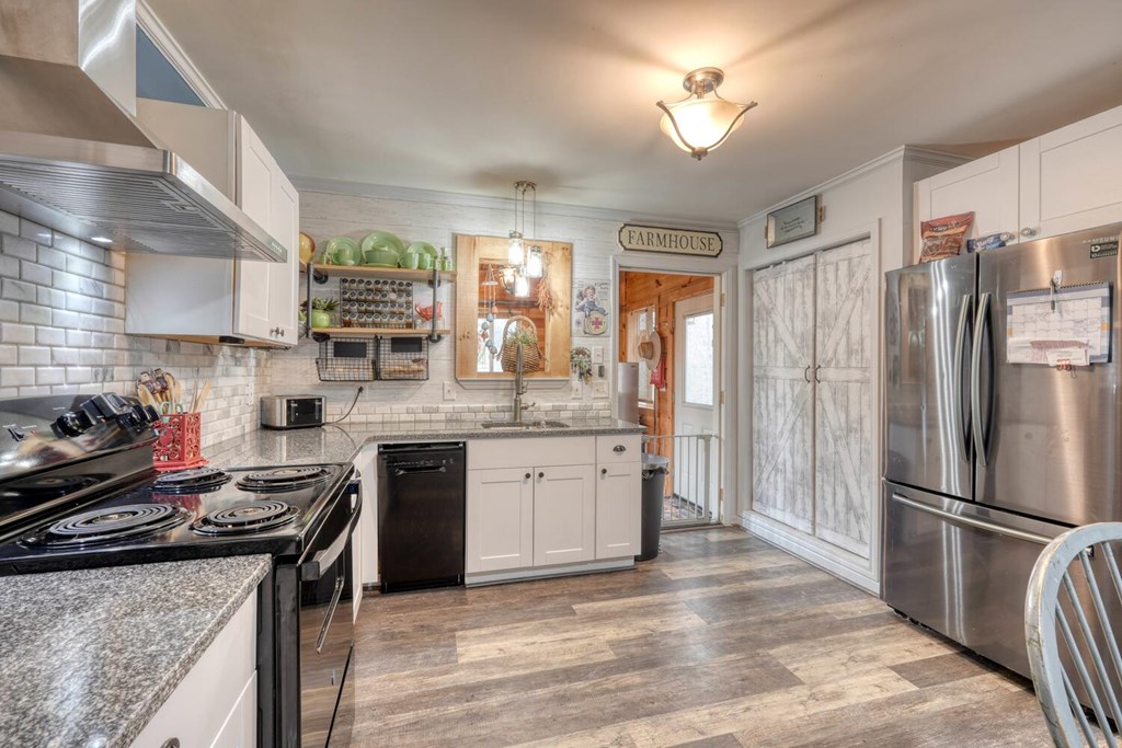 109 Hefner Road Blairsville, GA 30512 - Photo 11 of 48 a kitchen with a stove a sink and a refrigerator