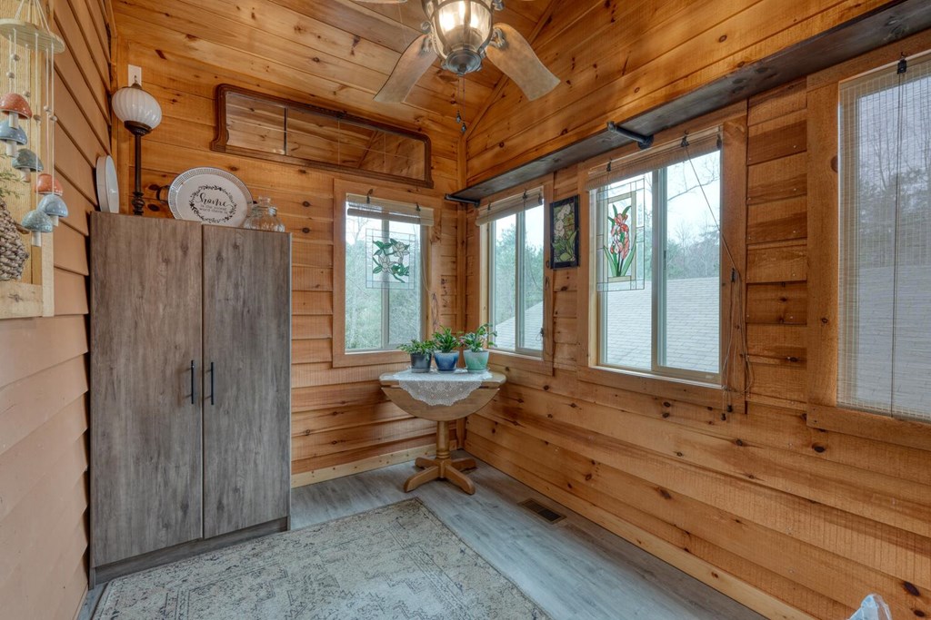 109 Hefner Road Blairsville, GA 30512 - Photo 12 of 48 a room with wooden walls and outdoor seating