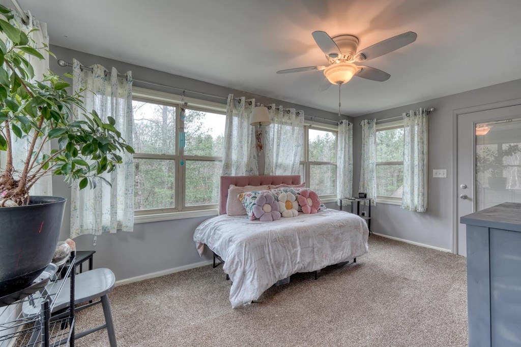 109 Hefner Road Blairsville, GA 30512 - Photo 14 of 48 a bedroom with a bed and a chandelier