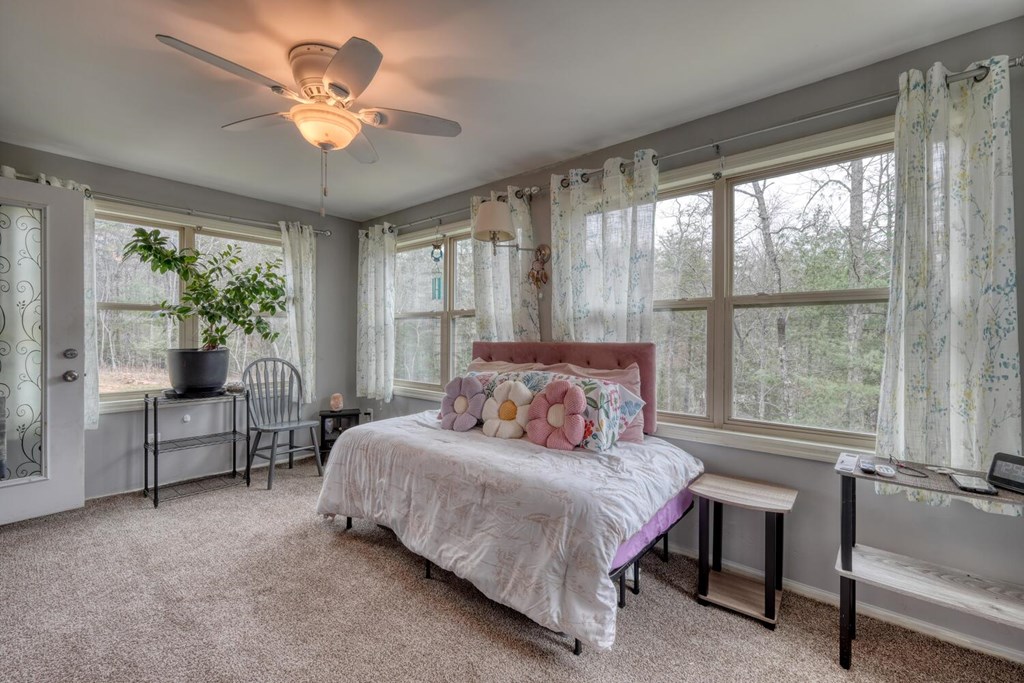 109 Hefner Road Blairsville, GA 30512 - Photo 15 of 48 a bedroom with a large bed and a chandelier