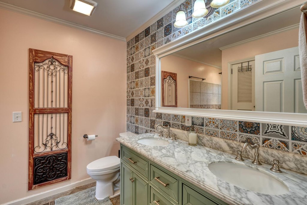 109 Hefner Road Blairsville, GA 30512 - Photo 20 of 48 a bathroom with a granite countertop double vanity sink a mirror and a toilet