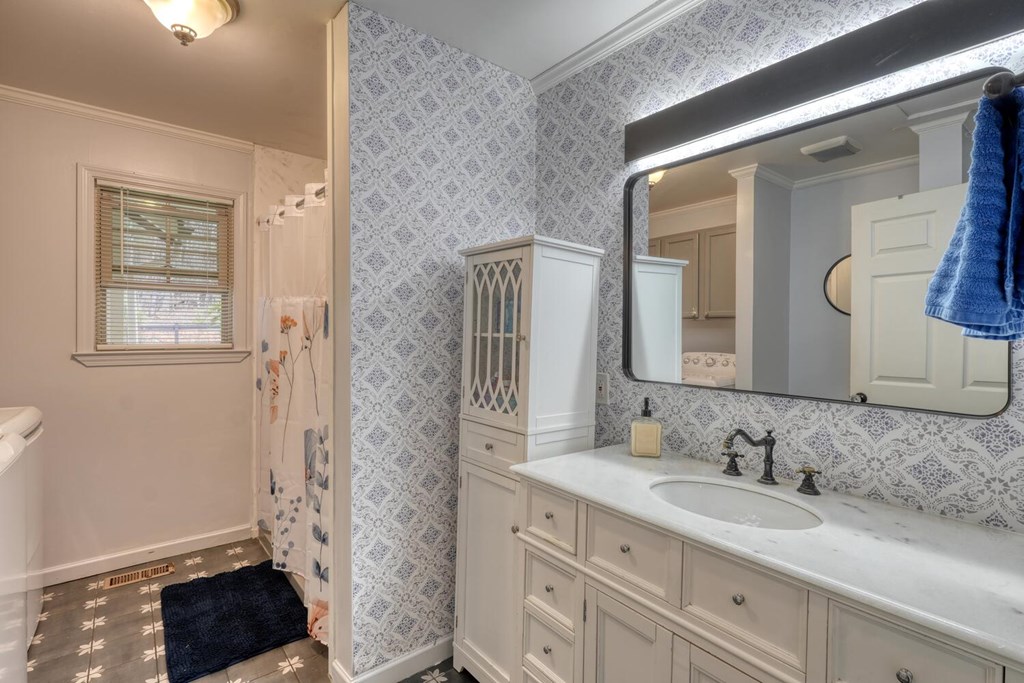 109 Hefner Road Blairsville, GA 30512 - Photo 23 of 48 a bathroom with a granite countertop sink a mirror and a shower