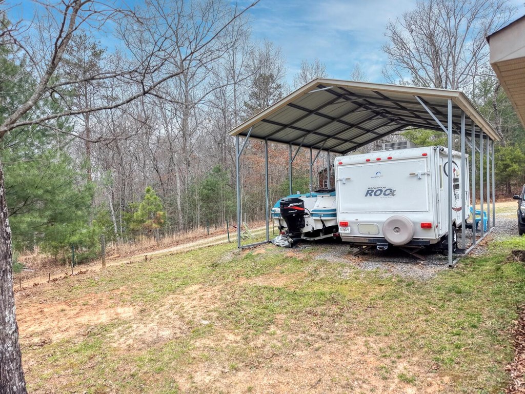 109 Hefner Road Blairsville, GA 30512 - Photo 41 of 48 a view of a backyard with a car and large trees