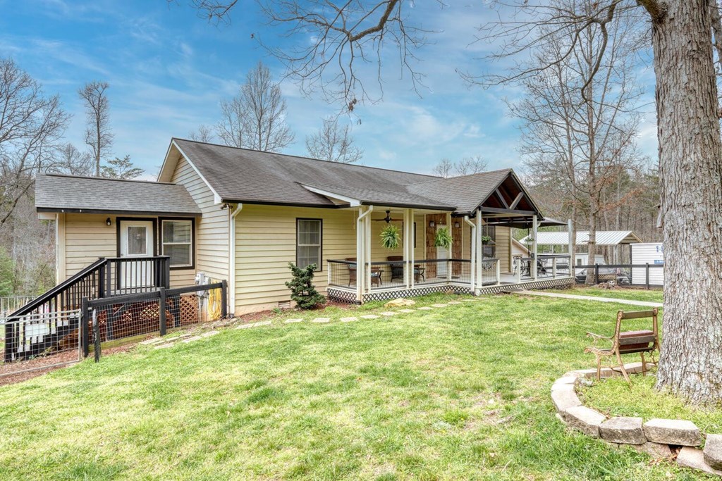 109 Hefner Road Blairsville, GA 30512 - Photo 5 of 48 a front view of a house with a yard table and chairs