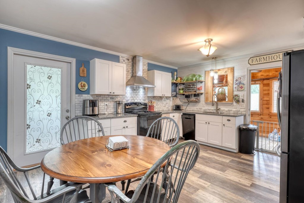 109 Hefner Road Blairsville, GA 30512 - Photo 8 of 48 a kitchen with stainless steel appliances granite countertop a dining table chairs and view living room