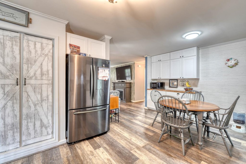 109 Hefner Road Blairsville, GA 30512 - Photo 10 of 48 a kitchen with stainless steel appliances a refrigerator a stove a dining table and chairs