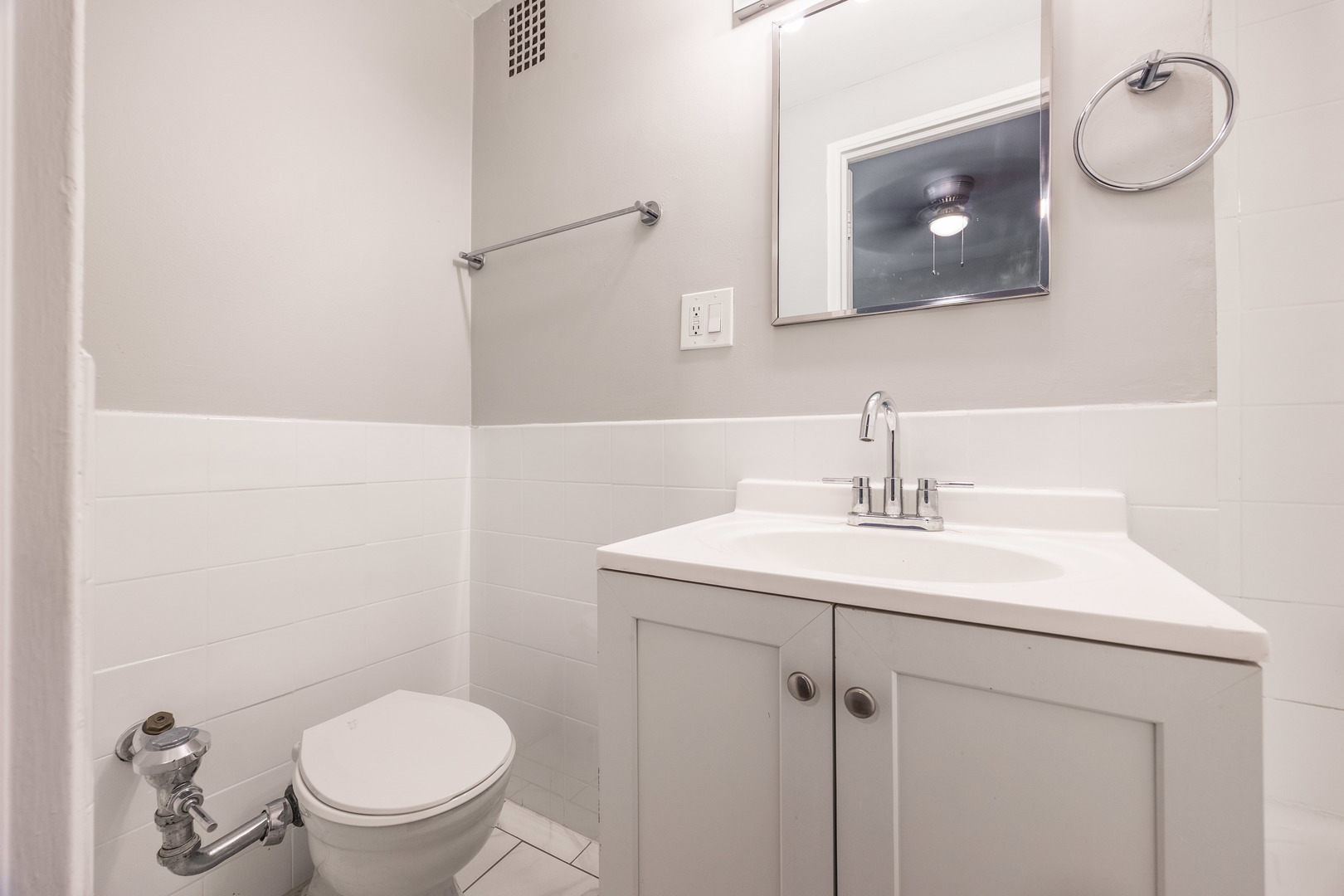 1140 North LaSalle Drive, Unit 203 Chicago, IL 60610 - Photo 11 of 25 a bathroom with a toilet a sink and mirror