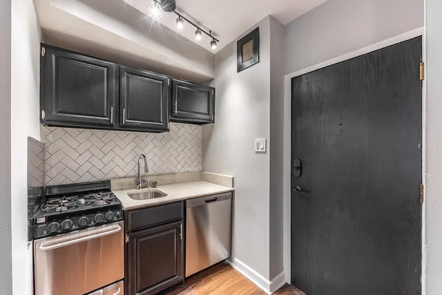 a kitchen with stainless steel appliances granite countertop a stove and a microwave