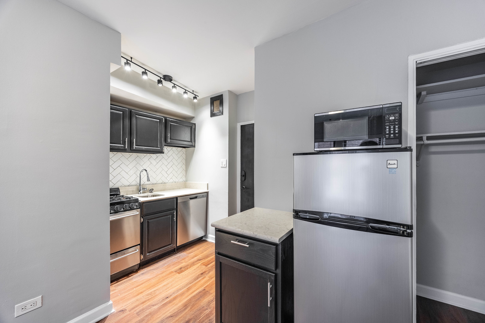 1140 North LaSalle Drive, Unit 203 Chicago, IL 60610 - Photo 4 of 25 a kitchen with a refrigerator sink and stove top oven