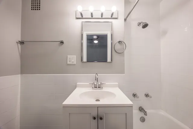 a bathroom with a sink a mirror and a shower