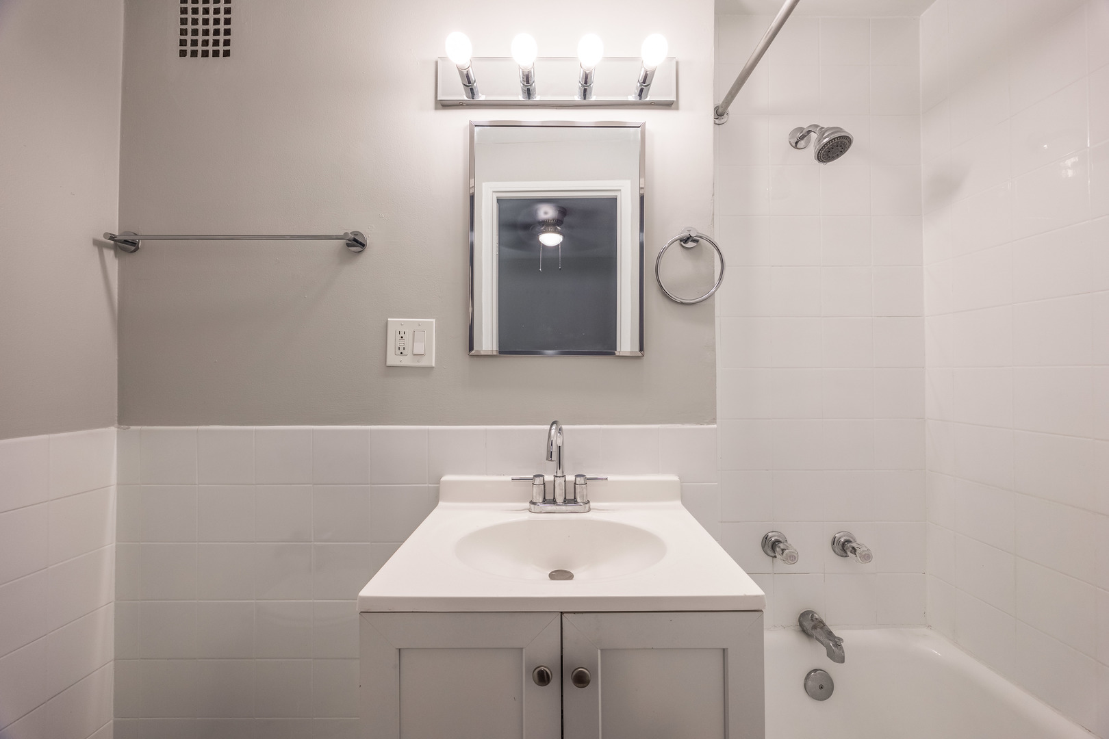 1140 North LaSalle Drive, Unit 203 Chicago, IL 60610 - Photo 9 of 25 a bathroom with a sink a mirror and a shower