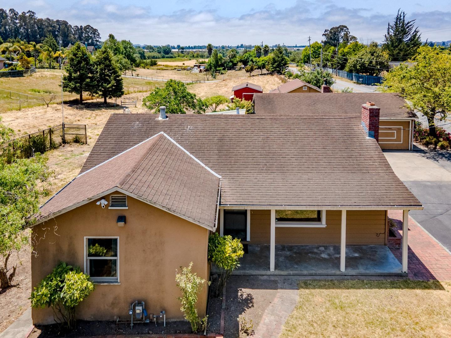 an aerial view of a house with a yard