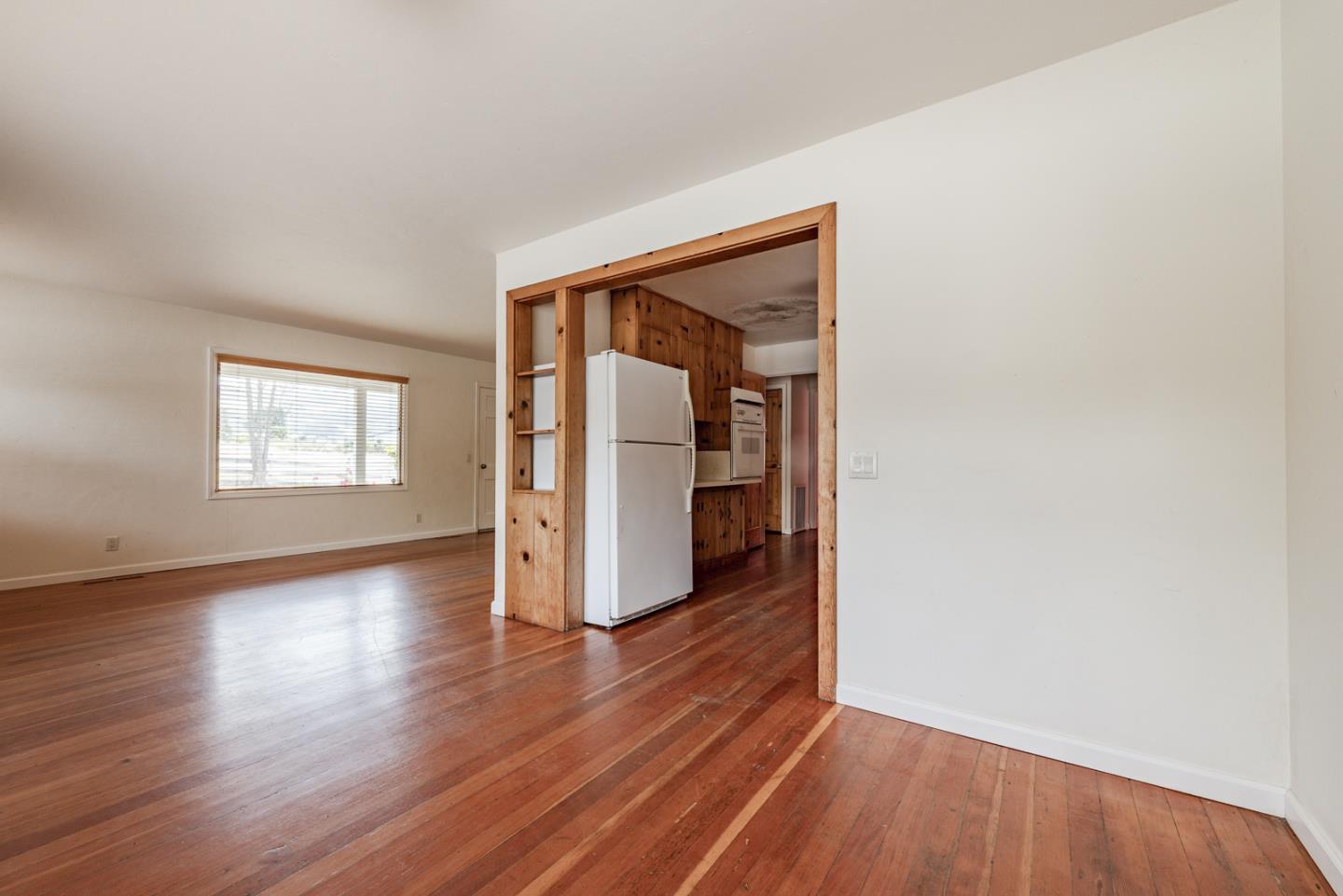 137 Whiting Road Watsonville, CA 95076 - Photo 11 of 52 an empty room with wooden floor and windows